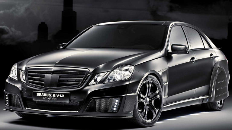 A sleek black luxury car with tinted windows and stylish rims.