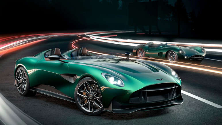 A sleek green sports car with headlights on, captured with light trails at night.