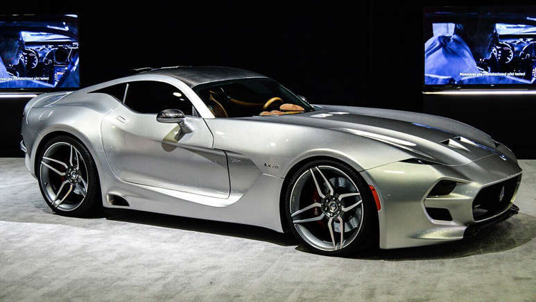 Sleek silver sports car with modern design and shiny rims.