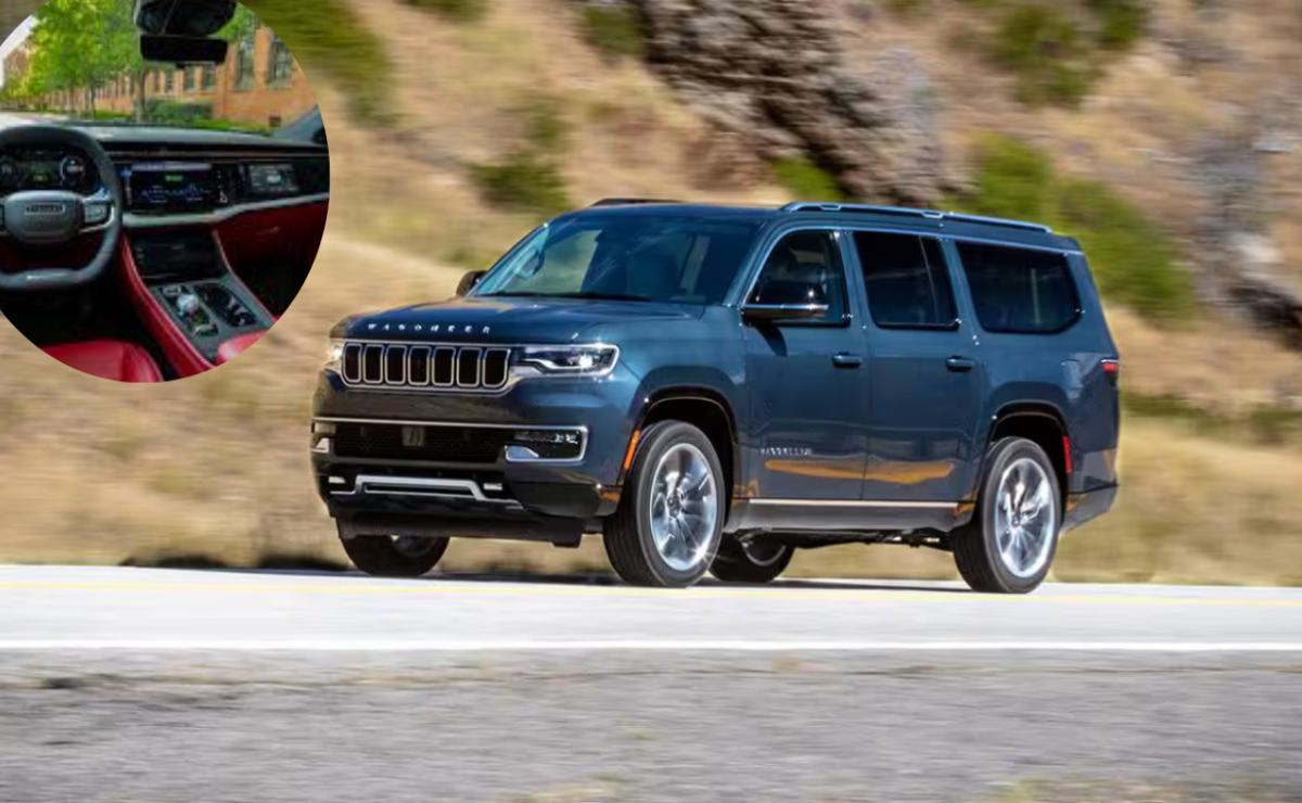 A dark-colored Jeep SUV driving on a road.