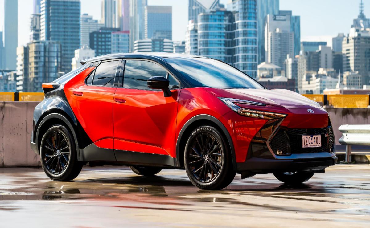A sleek red electric SUV parked in an urban setting.