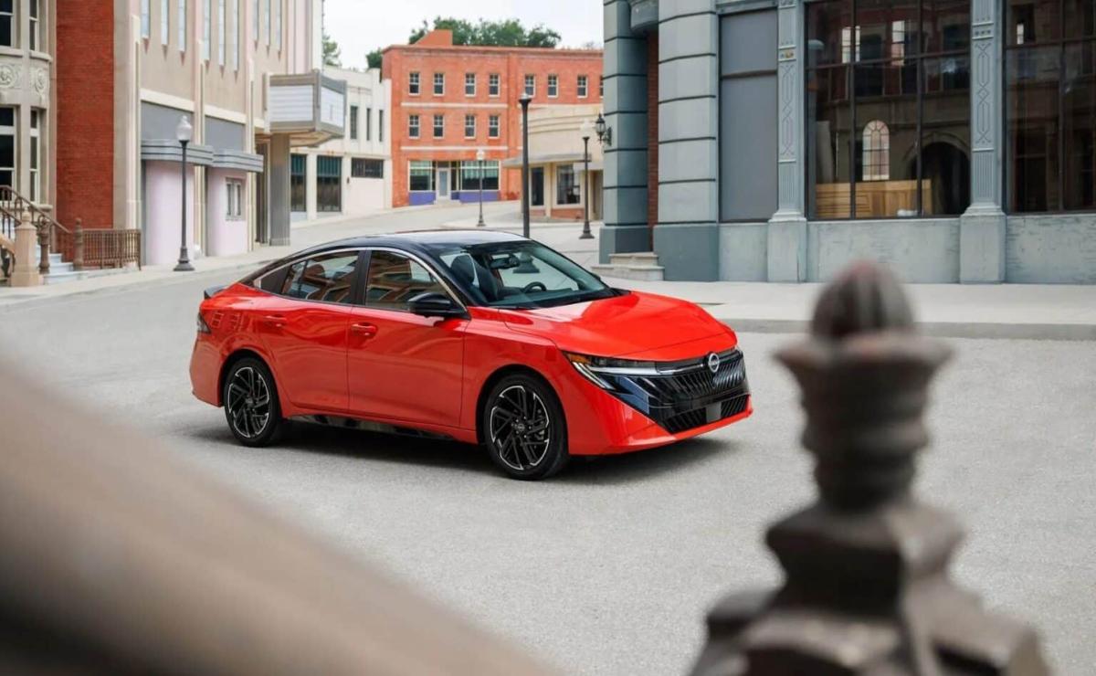 Sleek red sports sedan parked on a city street.
