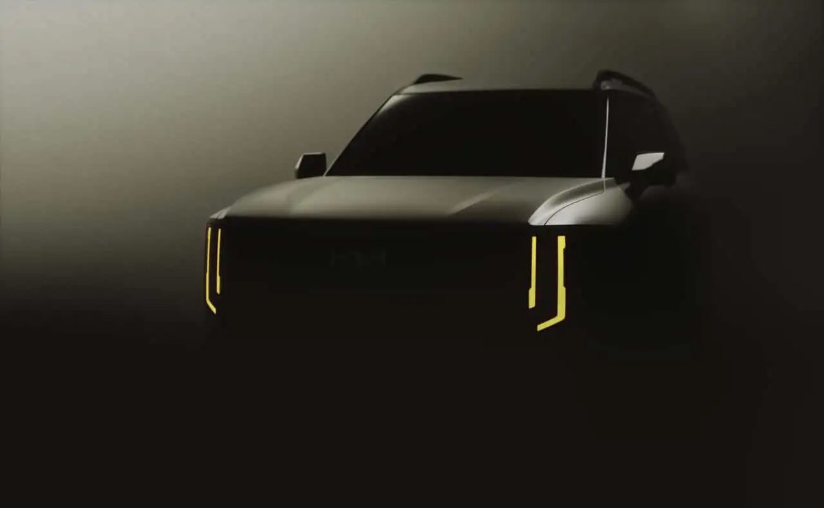 A sleek black car with distinctive vertical LED headlights in a dim setting.
