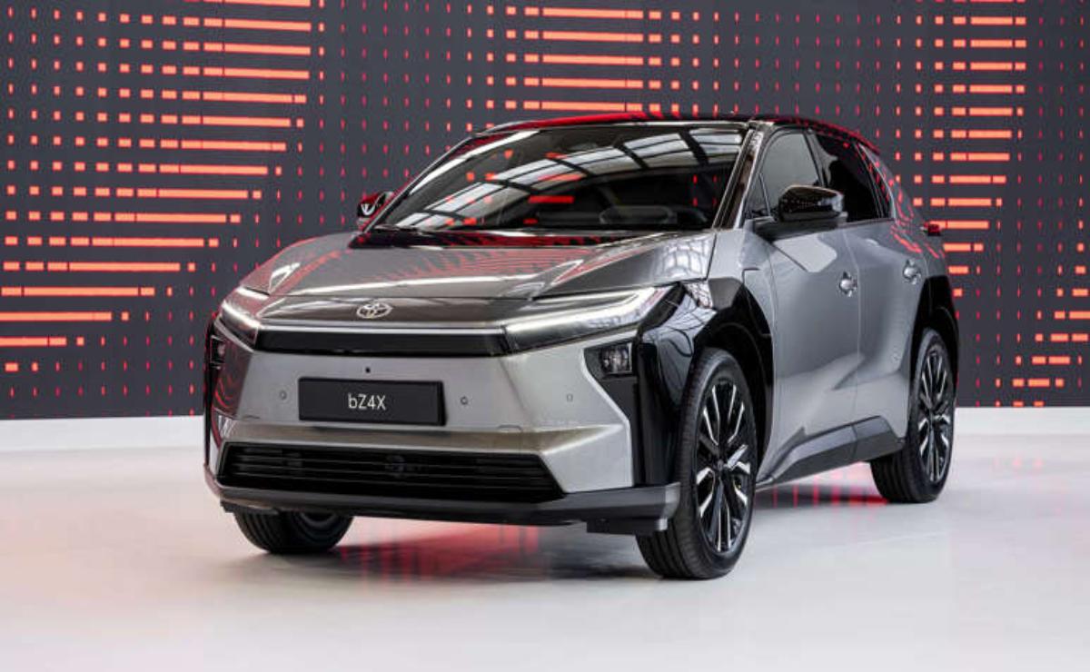 Sleek silver car showcased indoors with modern lighting.
