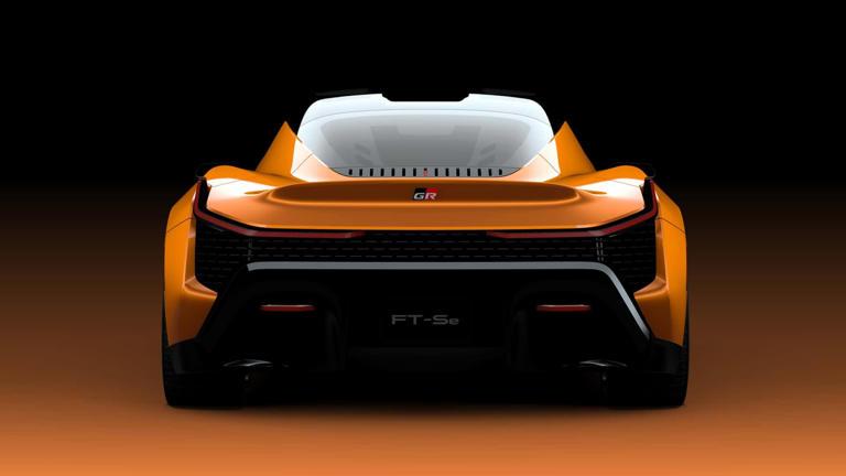 Rear view of an orange sports car with a prominent engine compartment.