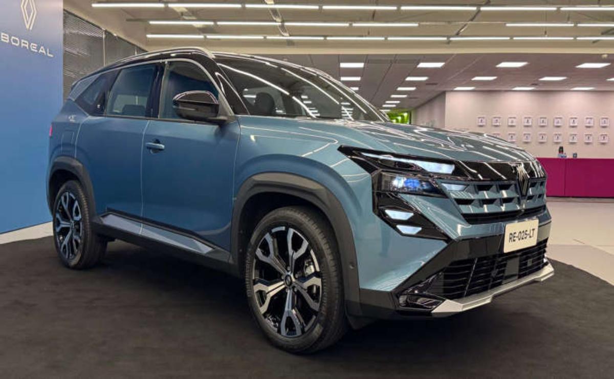 Side view of a modern blue SUV in a showroom.