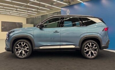 A sleek blue SUV displayed indoors at an auto show.