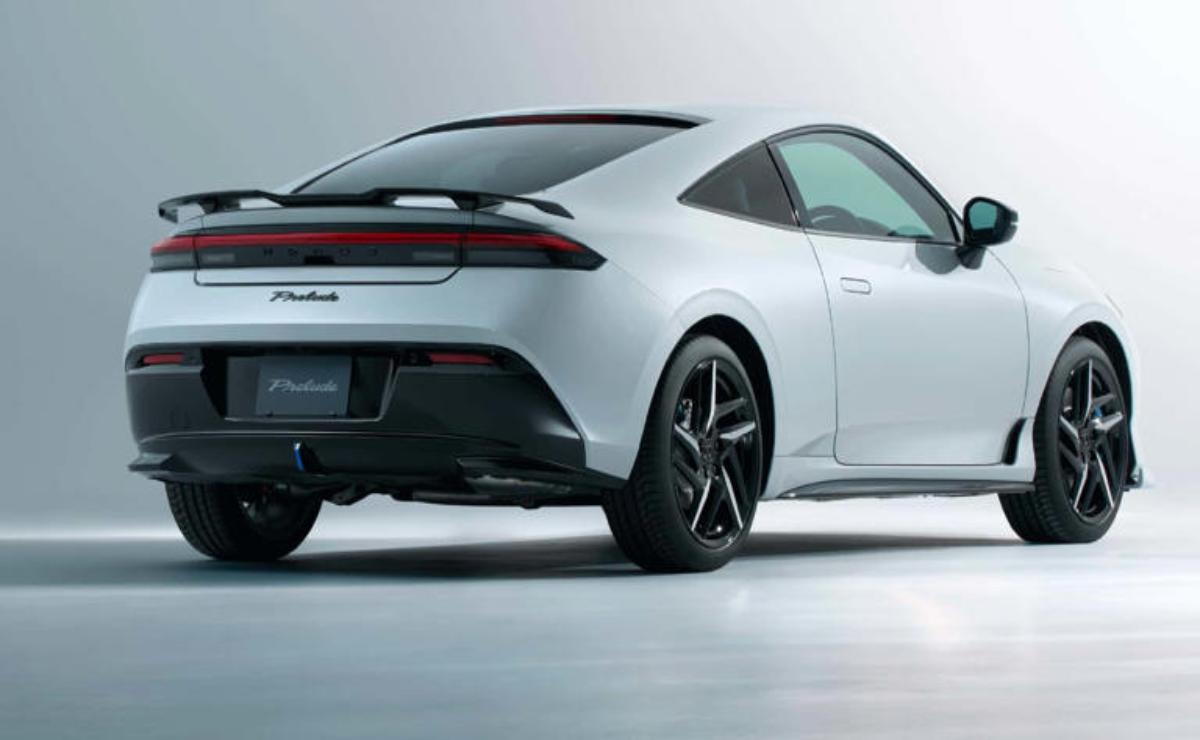 Sleek white Porsche sports car rear view with black wheels.