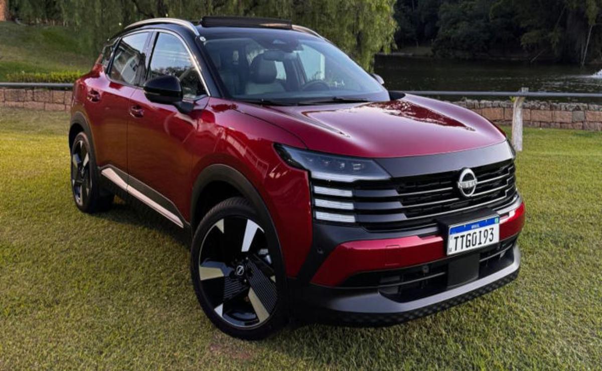 A sleek red SUV parked on grass with modern design details.