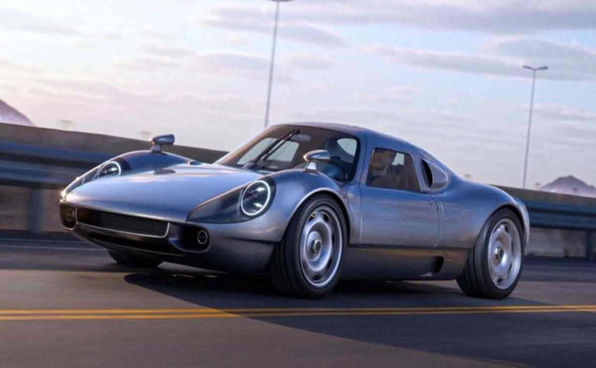 Sleek silver sports car driving on road during sunset.