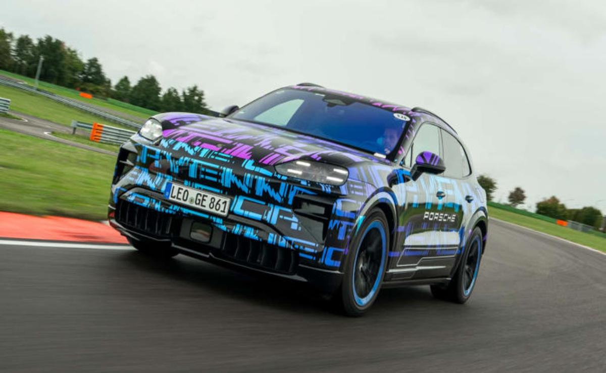 A modern electric SUV with vibrant tech-themed graphics on a road.