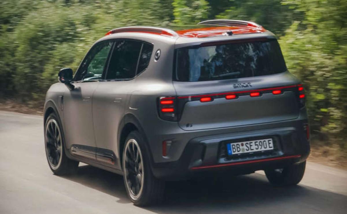 A sleek, modern SUV driving on a tree-lined road.