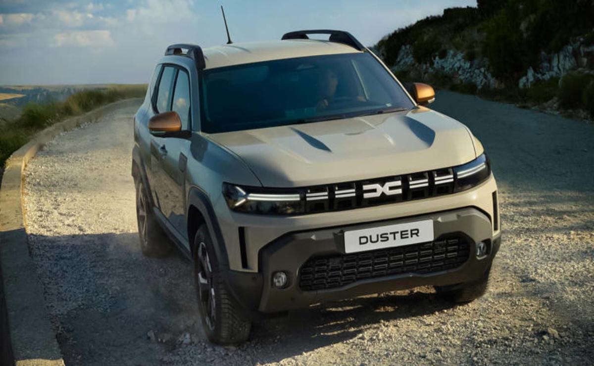 Silver Dacia Duster parked on a gravel road at sunset.