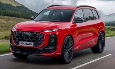 Red Audi Q5 driving on a scenic road.