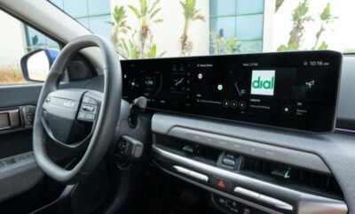 Interior view of a modern car dashboard with a wide digital display.