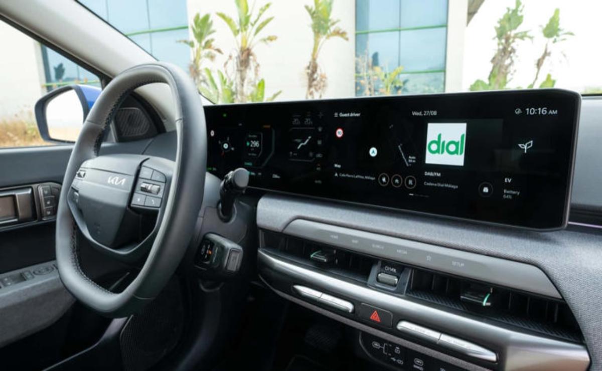 Interior view of a modern car dashboard with a wide digital display.