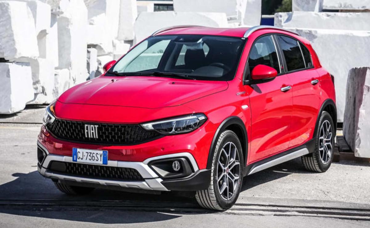Red Fiat Tipo parked outdoors in a sunny urban setting.