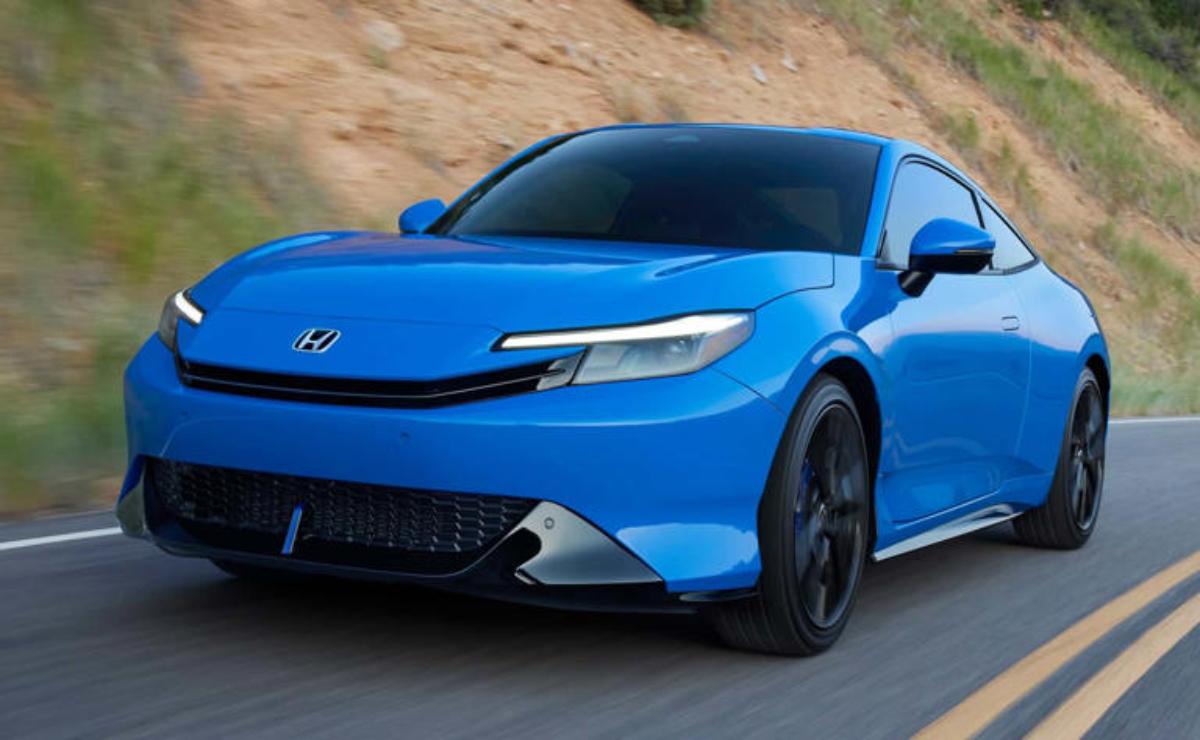 A sleek blue electric sports car driving on a road.