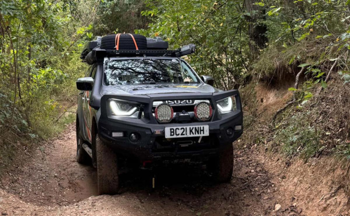 Off-road vehicle equipped for adventure driving on a forest trail.