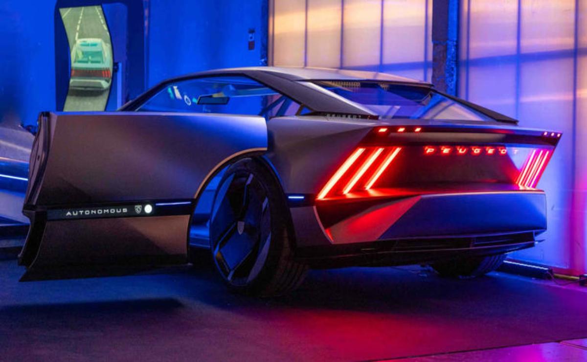 Sleek modern silver sports car with striking rear lights in blue and pink lighting.