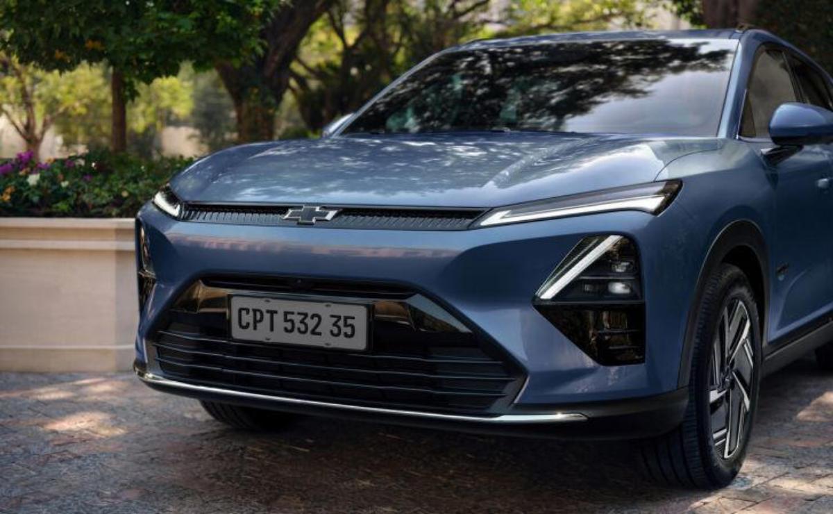 Front view of a sleek blue car with modern headlights.
