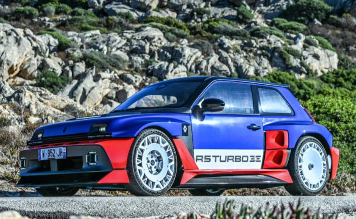 A blue and red sports car parked on rocky terrain.