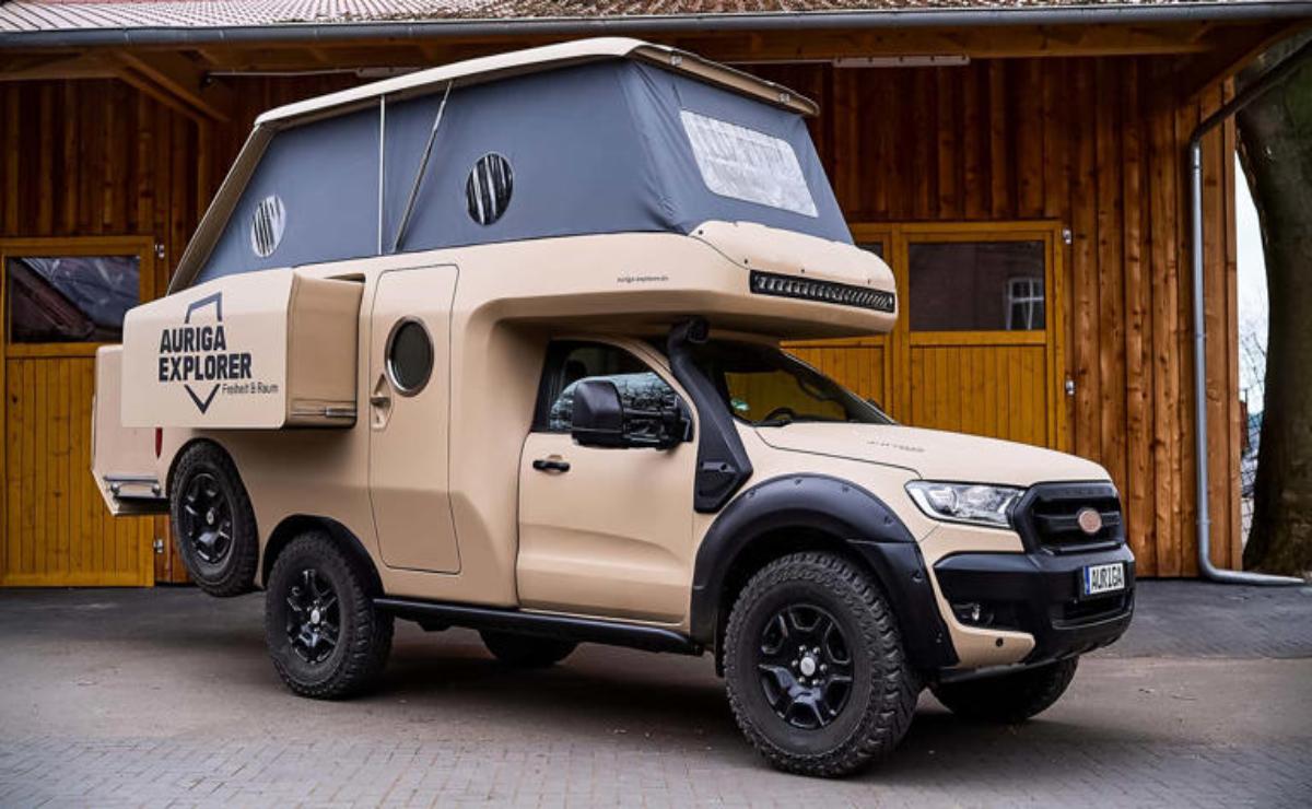 A rugged off-road vehicle with a built-in camper attachment.