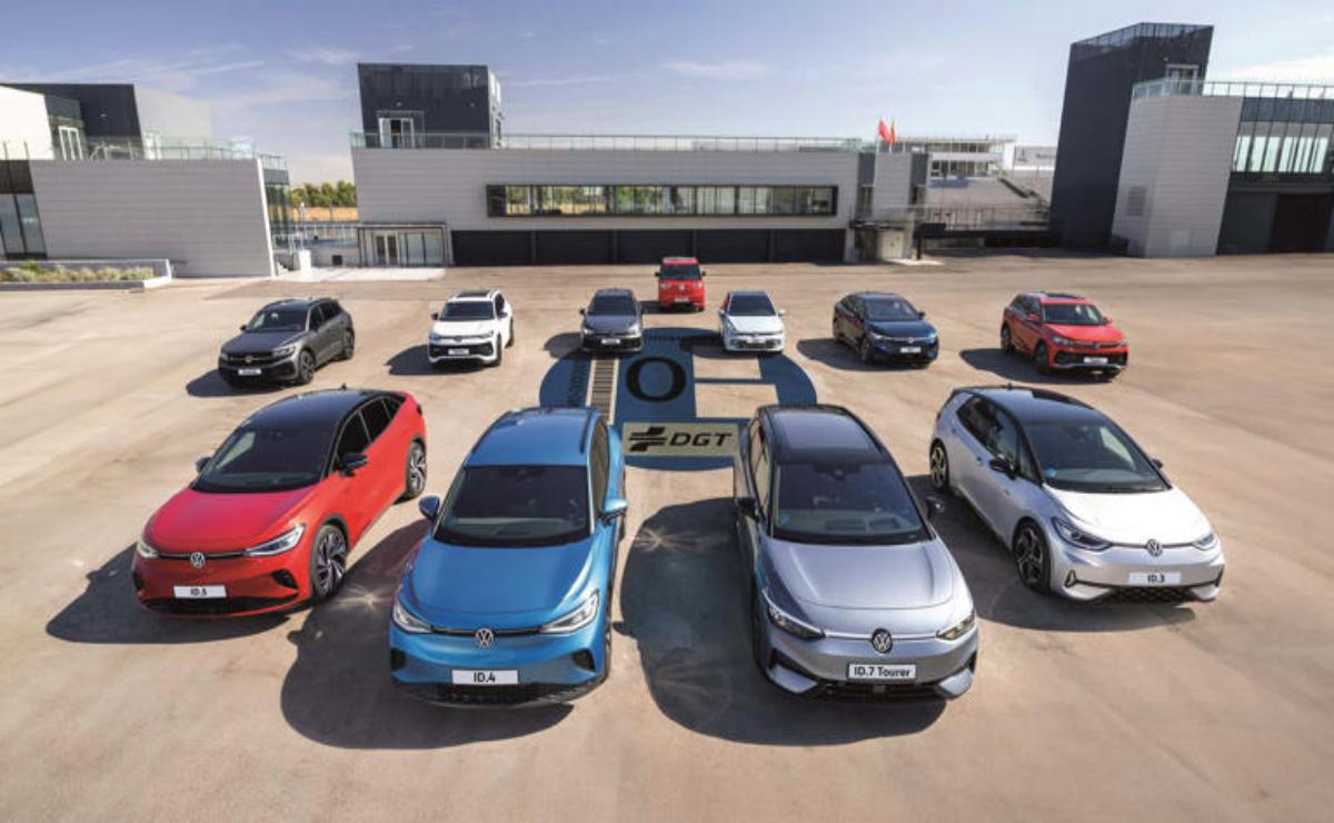 Electric cars charging at a station in a sunny parking lot.