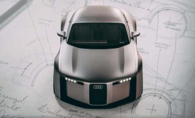 Top view of a sleek, futuristic Audi car design on blueprint paper.