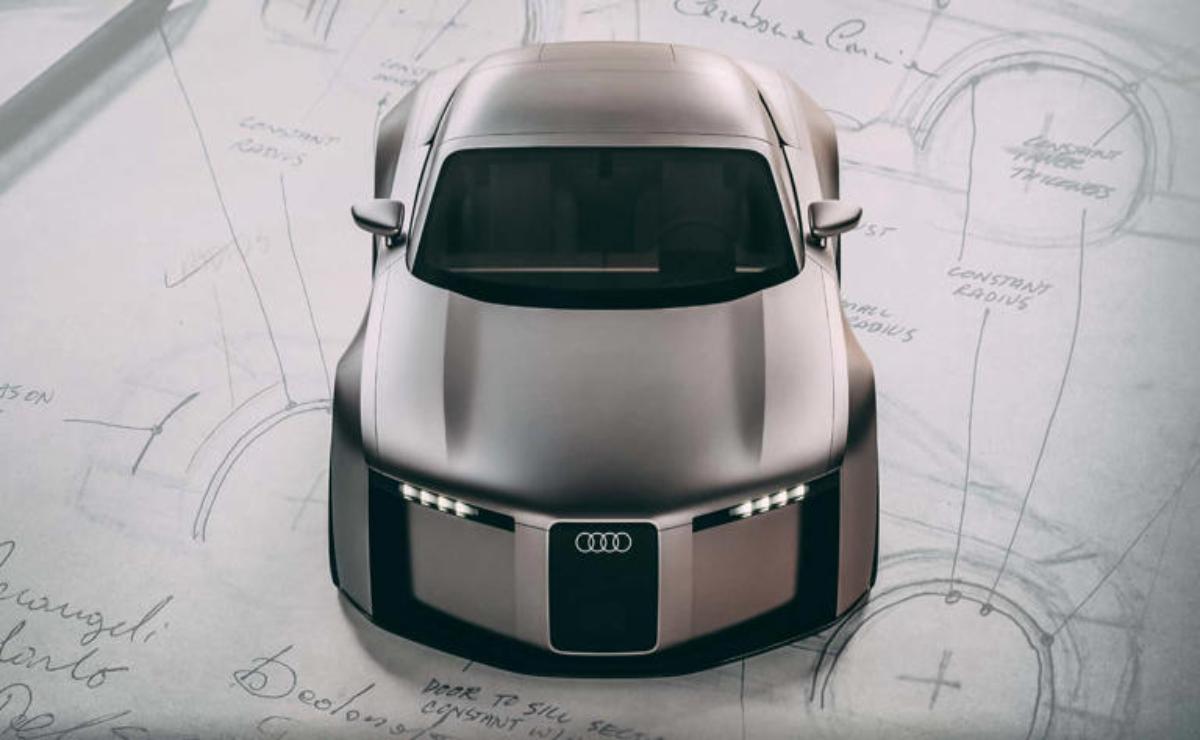 Top view of a sleek, futuristic Audi car design on blueprint paper.