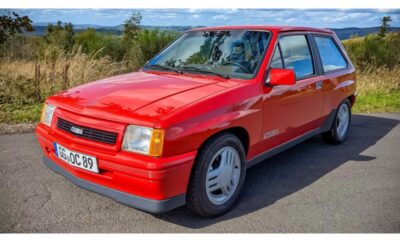 Red Opel Kadett GSi parked near the coast on a sunny day.