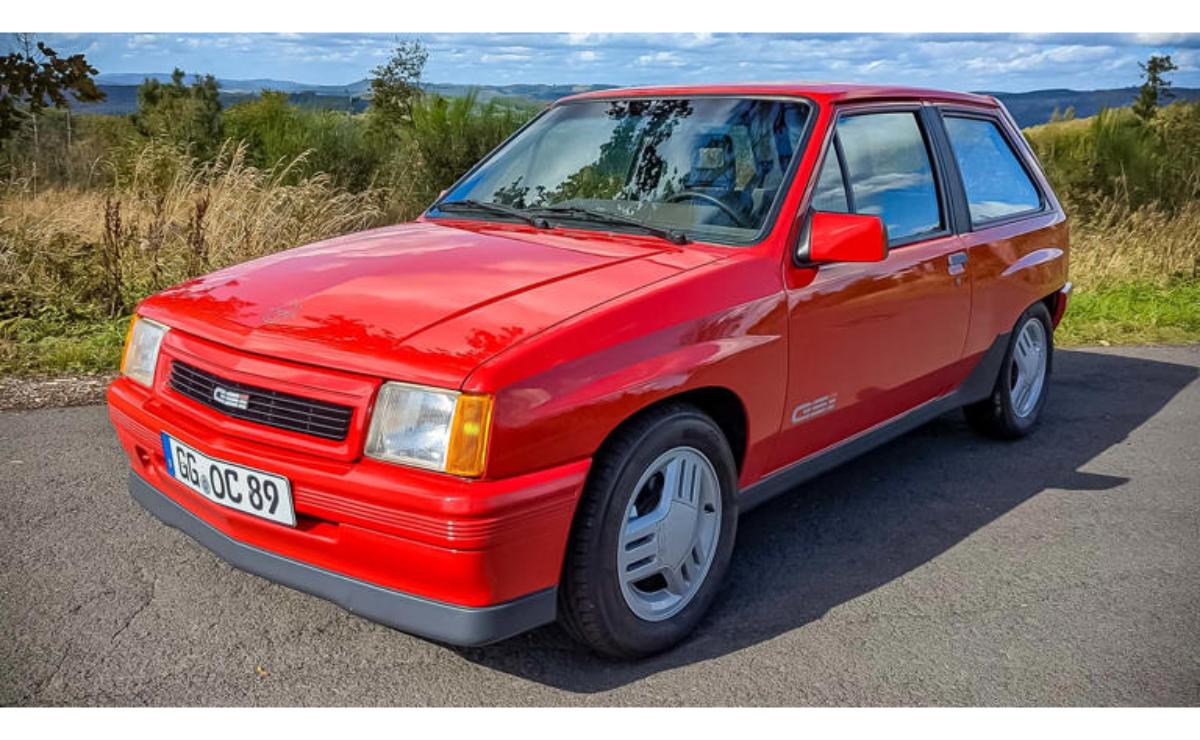 Red Opel Kadett GSi parked near the coast on a sunny day.
