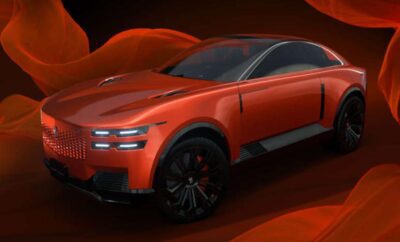 Sleek red futuristic electric car with aerodynamic design and black wheels.