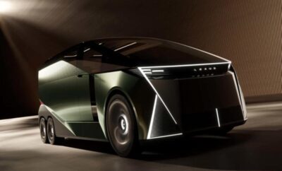 Futuristic electric car with sharp lines and LED lights in a dark setting.