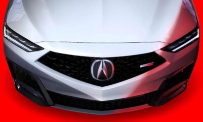 Close-up of an Acura car front grille with logo.