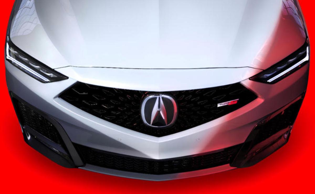 Close-up of an Acura car front grille with logo.