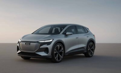Sleek silver Audi electric SUV parked on a smooth surface at dusk.