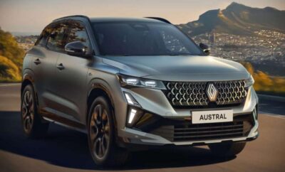 Renault Austral SUV parked with scenic mountain backdrop during sunset.