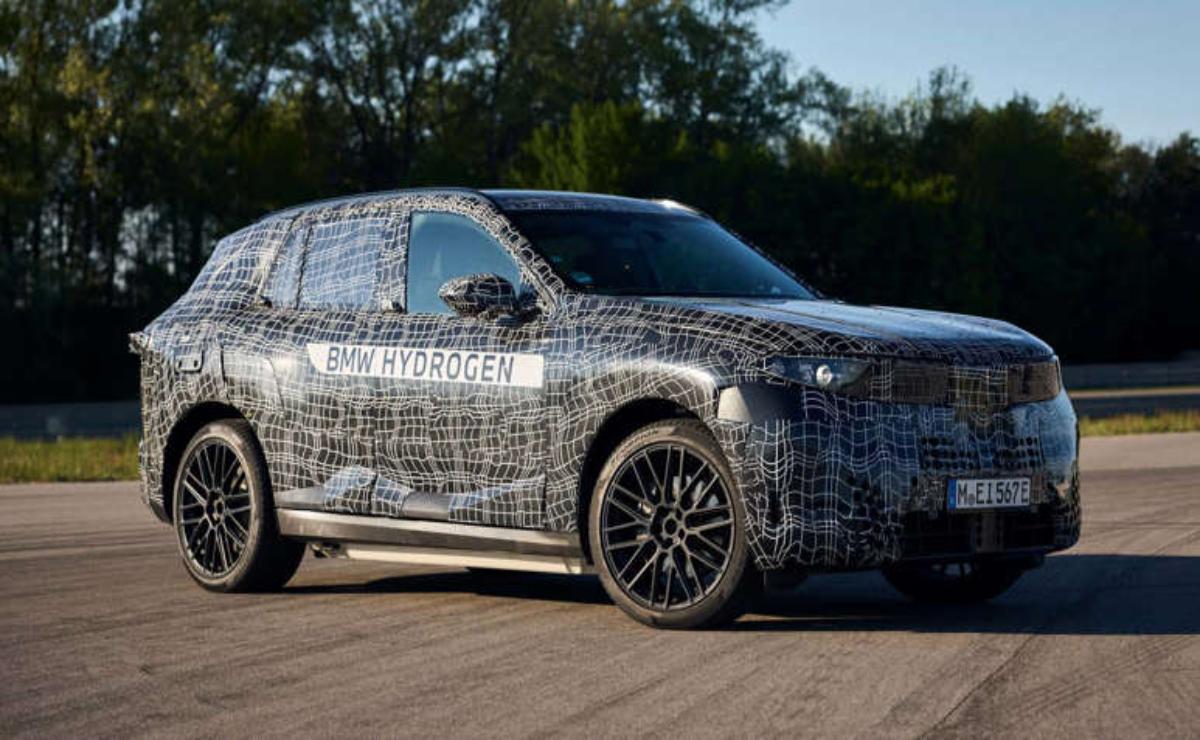 A camouflaged luxury SUV undergoing testing outdoors.