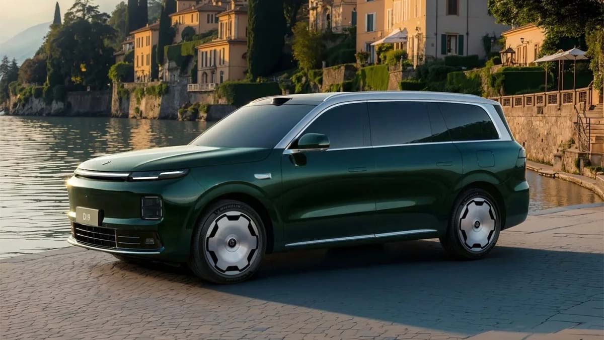 Sleek green SUV parked by a waterfront with historic buildings.