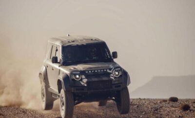 A rugged off-road vehicle driving over desert terrain.