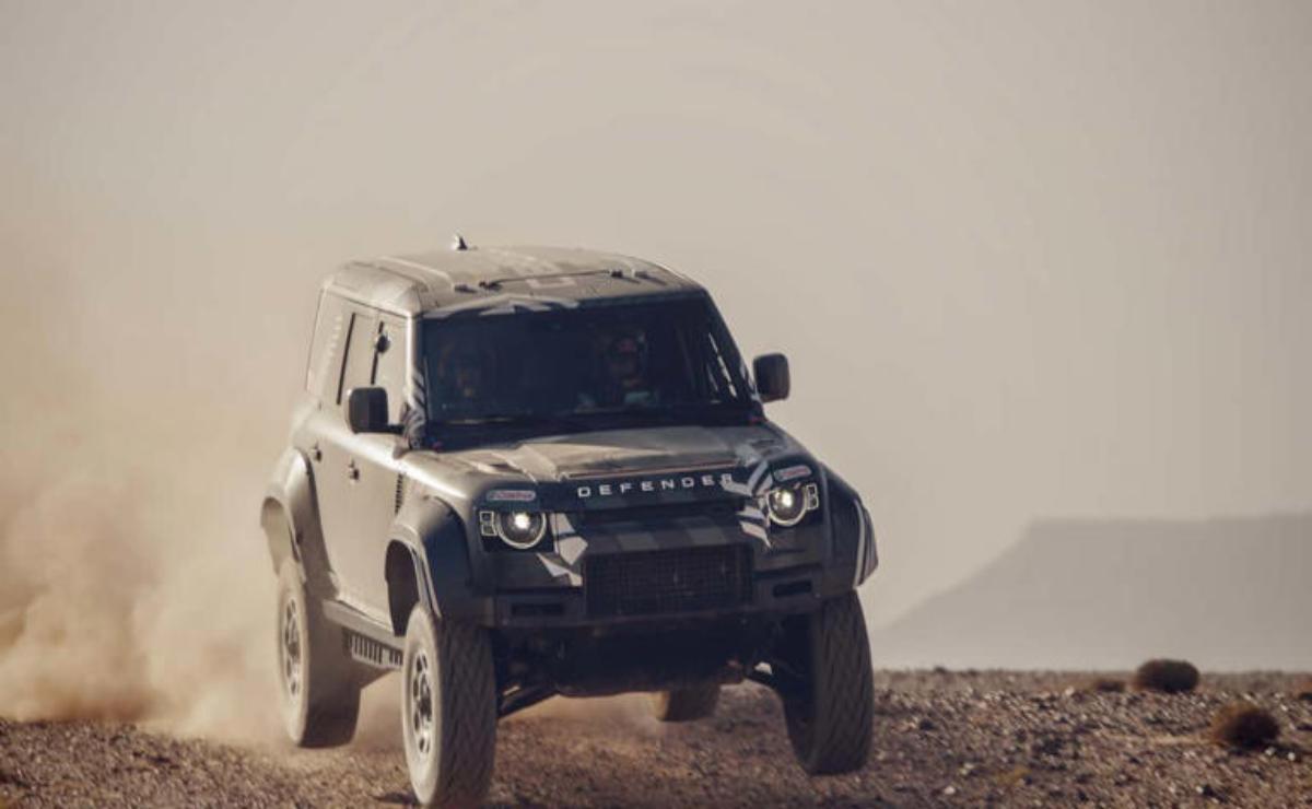 A rugged off-road vehicle driving over desert terrain.