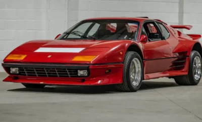 A sleek red sports car parked indoors.