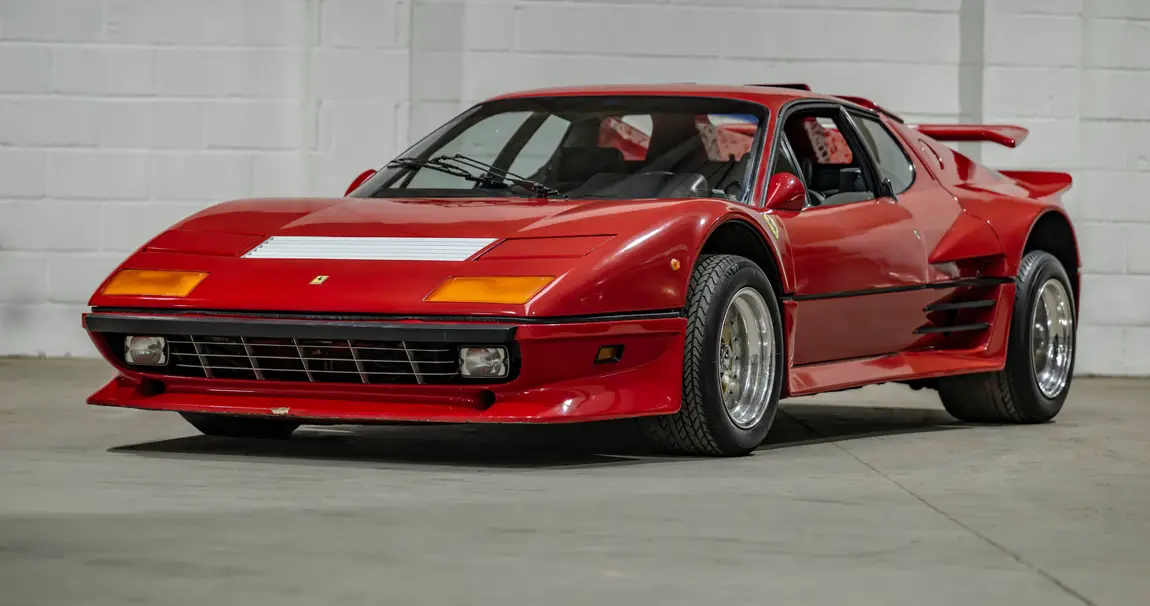 A sleek red sports car parked indoors.