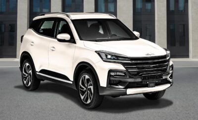 White modern SUV parked in front of a building.
