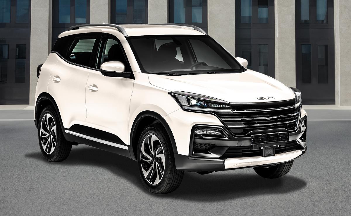White modern SUV parked in front of a building.