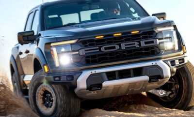 Close-up of a rugged Ford truck driving off-road on dirt terrain.