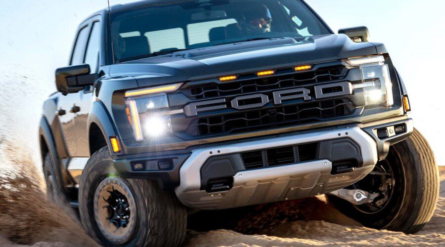 Close-up of a rugged Ford truck driving off-road on dirt terrain.