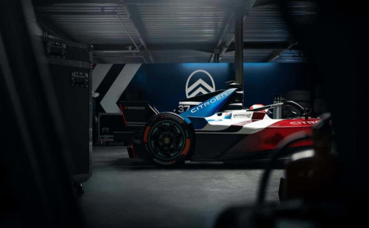 Close-up of a sleek racing car in a dimly lit garage.
