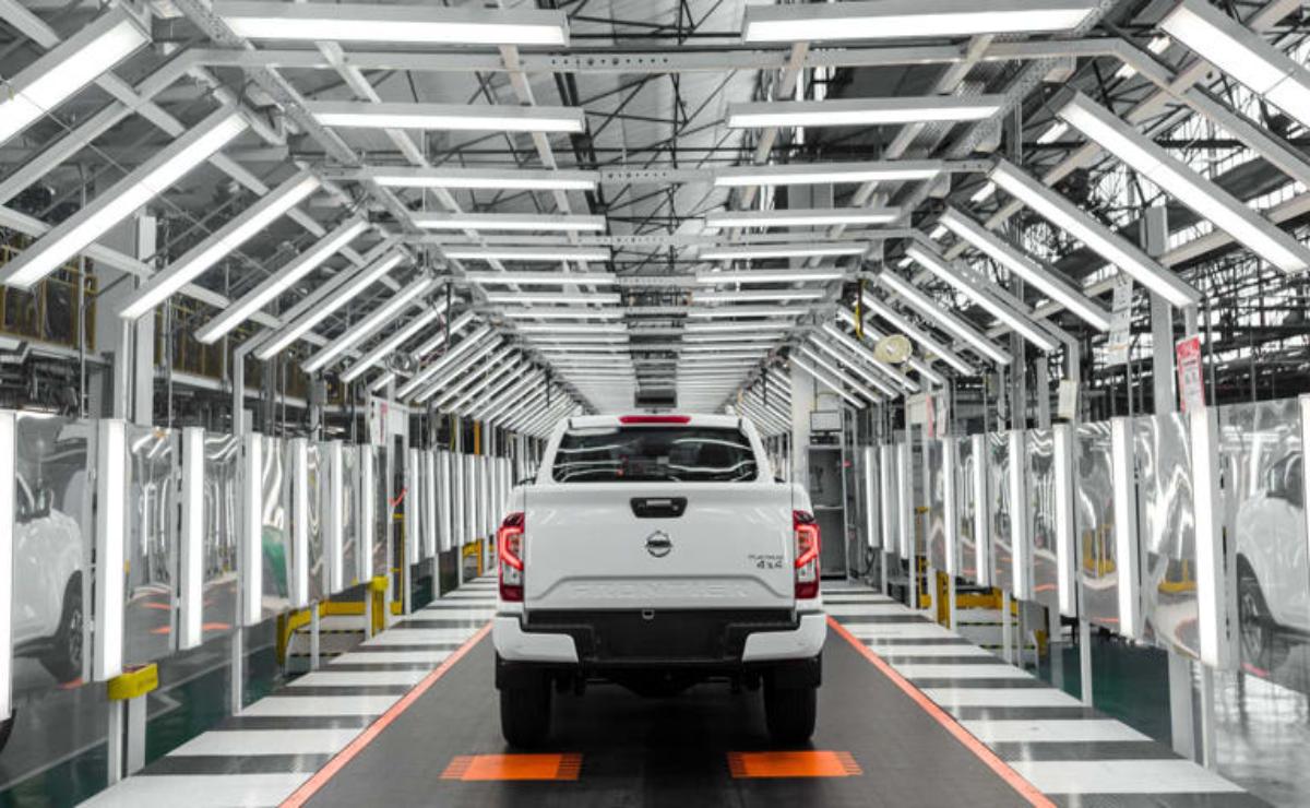 White pickup truck on an automated assembly line.